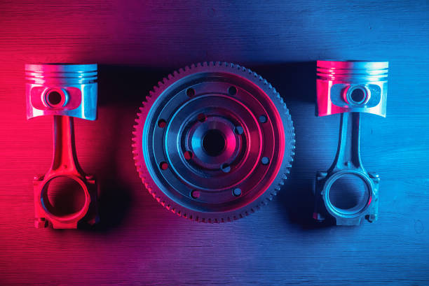 A car gearbox wheel and engine piston flat lay abstract background. A car gearbox wheel and engine piston flat lay abstract background.